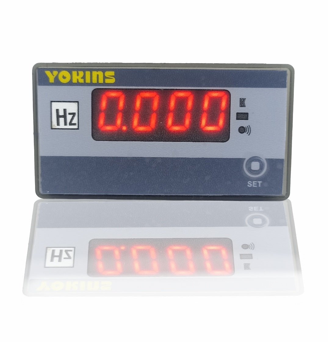 Yokins Instruments AC frequency meter displaying digital readout of Hz measurement on a white background.